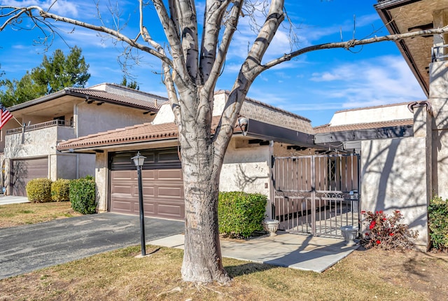 front of property featuring a garage and a balcony