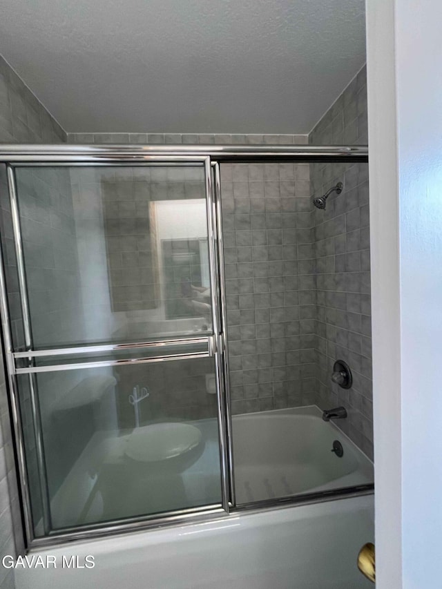 28714 Cruthers Creek Rd, Pearblossom, CA 93553 - bathroom with shower / bath combination with glass door and a textured ceiling