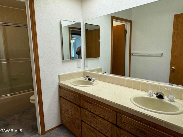 28714 Cruthers Creek Rd, Pearblossom, CA 93553 - bathroom featuring double vanity, a textured wall, and shower / bath combination with glass door