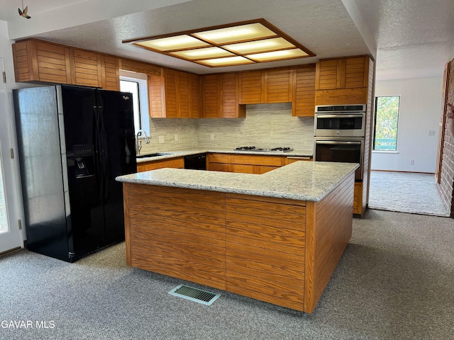 28714 Cruthers Creek Rd, Pearblossom, CA 93553 - kitchen featuring black fridge, carpet, double oven, brown cabinets, and a textured ceiling
