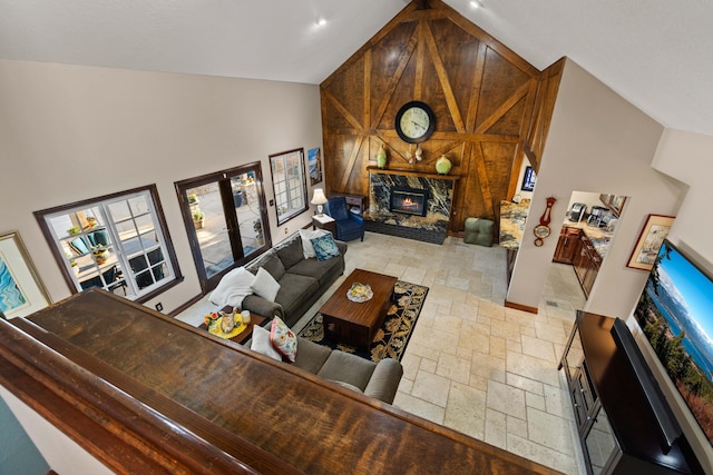 436 Fairway Dr, Palmdale, CA 93551 - living area featuring stone tile floors, high vaulted ceiling, french doors, a stone fireplace, and wooden walls