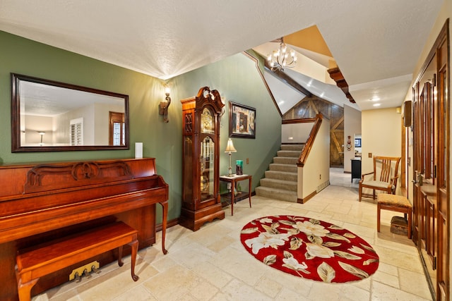 436 Fairway Dr, Palmdale, CA 93551 - sitting room with stone tile flooring, baseboards, stairway, a textured ceiling, and a chandelier