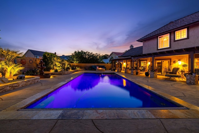436 Fairway Dr, Palmdale, CA 93551 - pool at dusk featuring a patio and a fenced backyard