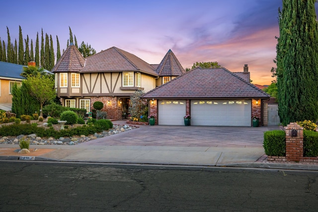 436 Fairway Dr, Palmdale, CA 93551 - view of front of property with an attached garage, driveway, stucco siding, a chimney, and brick siding