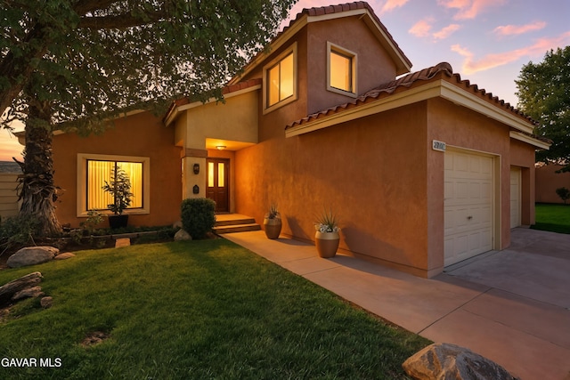 38100 San Mateo Ave, Palmdale, CA 93551 - mediterranean / spanish house featuring concrete driveway, a front yard, stucco siding, and a tile roof