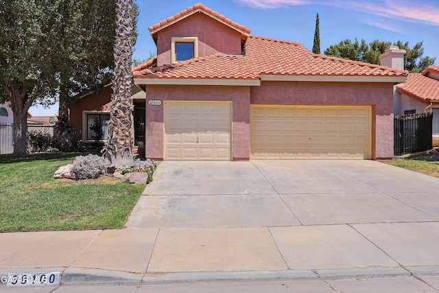 38100 San Mateo Ave, Palmdale, CA 93551 - mediterranean / spanish home with an attached garage, concrete driveway, stucco siding, and a tile roof