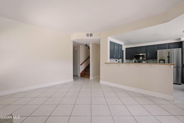38100 San Mateo Ave, Palmdale, CA 93551 - unfurnished living room featuring stairs and light tile patterned floors