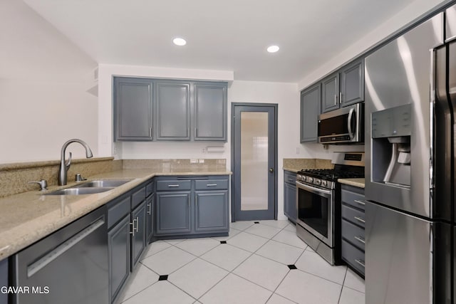 38100 San Mateo Ave, Palmdale, CA 93551 - kitchen with stainless steel appliances, light stone countertops, recessed lighting, light tile patterned floors, and gray cabinets