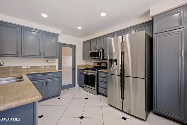 38100 San Mateo Ave, Palmdale, CA 93551 - kitchen with stainless steel appliances, recessed lighting, light tile patterned flooring, and light stone counters