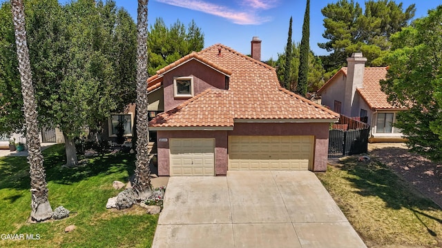 38100 San Mateo Ave, Palmdale, CA 93551 - view of front of house featuring stucco siding, an attached garage, driveway, and a tile roof