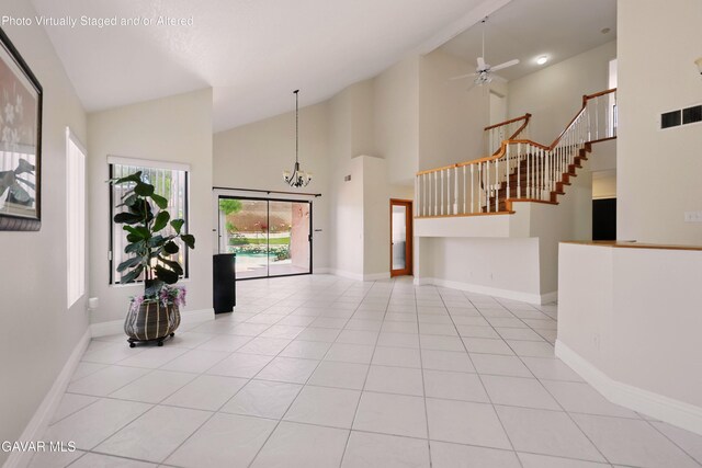 38100 San Mateo Ave, Palmdale, CA 93551 - unfurnished living room featuring stairway, high vaulted ceiling, light tile patterned floors, a ceiling fan, and a chandelier