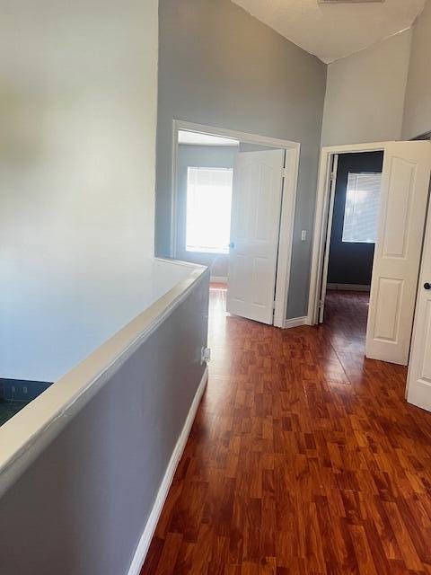 corridor featuring dark hardwood / wood-style floors