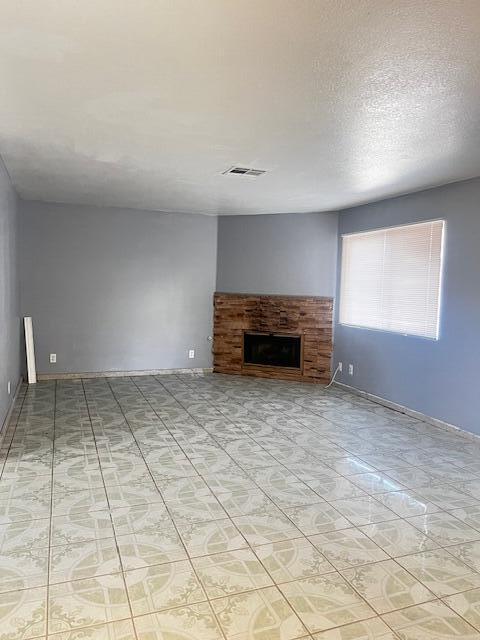 unfurnished living room featuring a textured ceiling