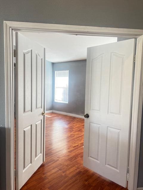 hallway with hardwood / wood-style floors