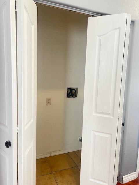 clothes washing area featuring tile patterned floors