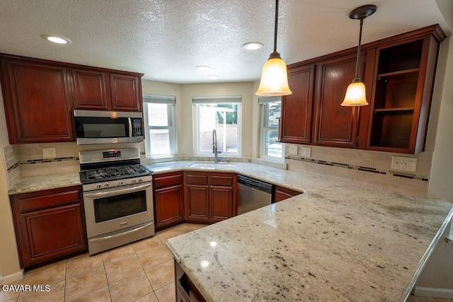 4722 Sungate Dr, Palmdale, CA 93551 - kitchen featuring stainless steel appliances, tasteful backsplash, hanging light fixtures, light stone countertops, and a textured ceiling