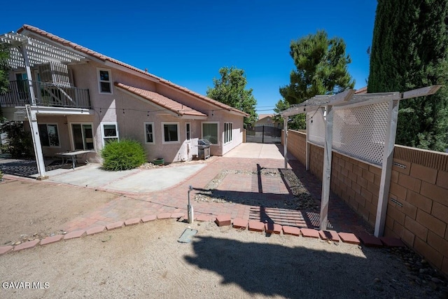 4722 Sungate Dr, Palmdale, CA 93551 - back of house featuring a pergola, a patio, and stucco siding