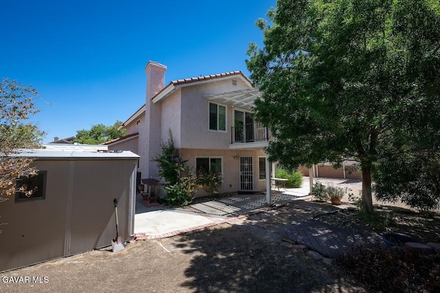 4722 Sungate Dr, Palmdale, CA 93551 - view of front of house featuring a chimney, stucco siding, a balcony, a patio area, and a pergola