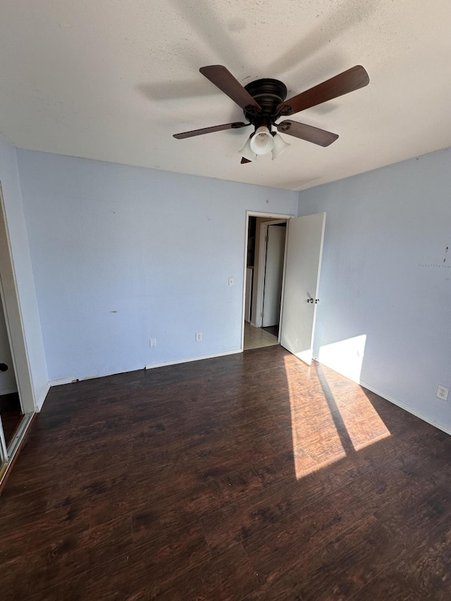 spare room with a textured ceiling, dark hardwood / wood-style flooring, and ceiling fan