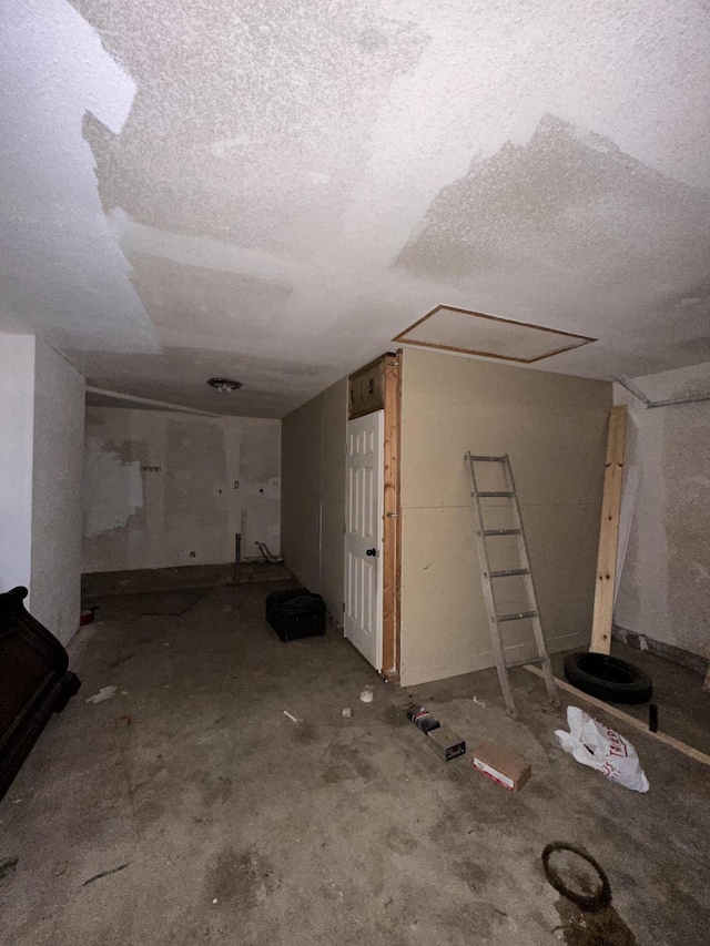 basement featuring a textured ceiling