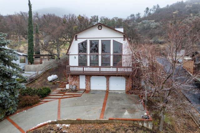 view of front of property featuring a garage and a deck