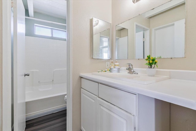 full bathroom featuring tub / shower combination, vanity, and toilet