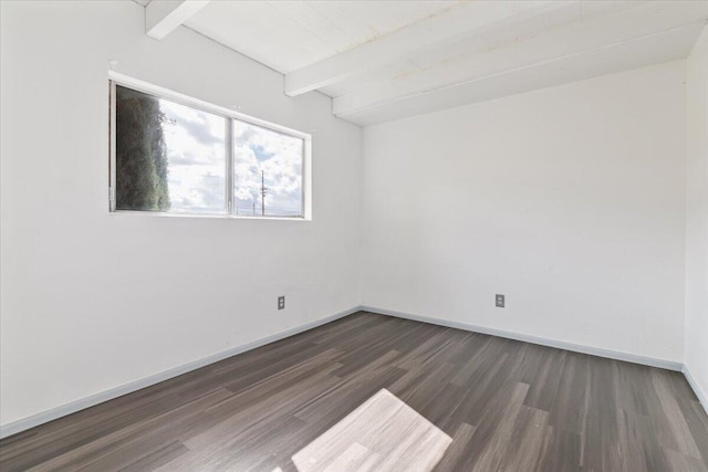 unfurnished room with lofted ceiling with beams, dark wood finished floors, and baseboards