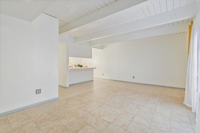 empty room featuring light tile patterned floors, wood ceiling, baseboards, and beamed ceiling