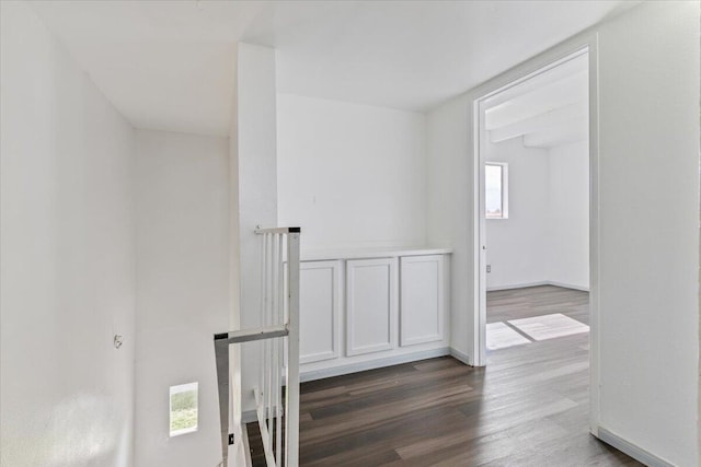 hall featuring dark wood finished floors and baseboards