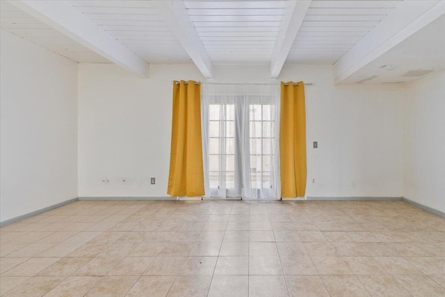 empty room with light tile patterned floors, beam ceiling, and baseboards