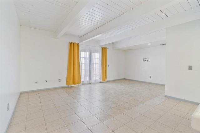 spare room featuring light tile patterned floors, baseboards, and beam ceiling