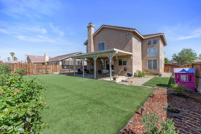 3616 Glenridge Ave, Rosamond, CA 93560 - back of property with a trampoline, stucco siding, a patio area, and a fenced backyard
