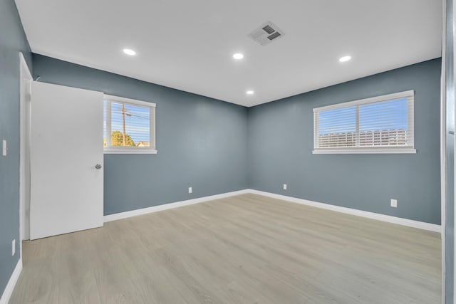 empty room with light hardwood / wood-style floors