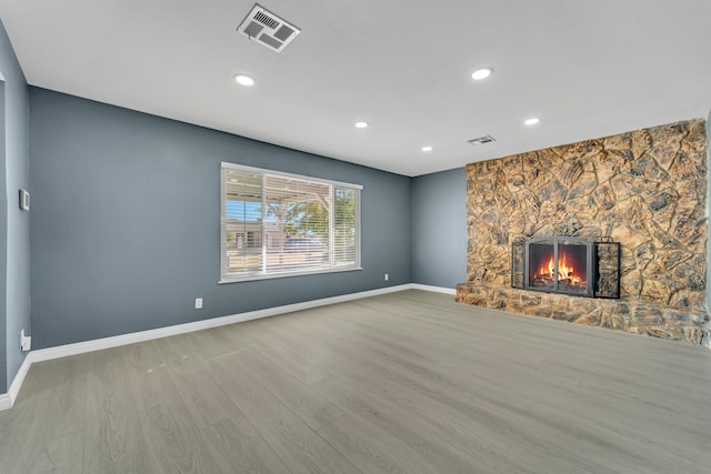 unfurnished living room with a fireplace and wood-type flooring