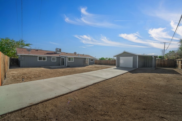 single story home featuring an outbuilding and a garage