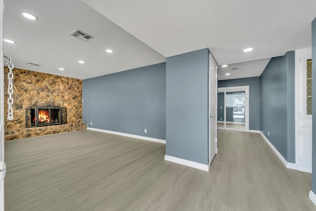 unfurnished living room featuring light hardwood / wood-style floors and a fireplace