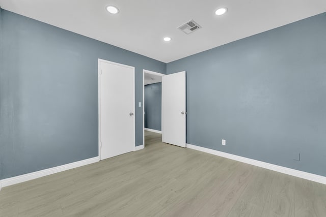 empty room with light hardwood / wood-style flooring