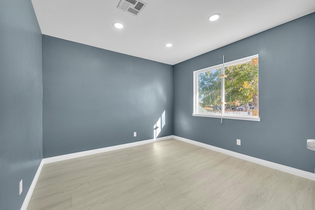 spare room featuring light hardwood / wood-style floors