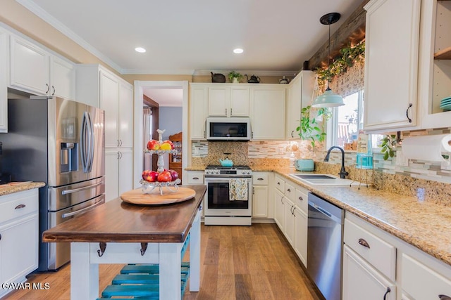 3455 Pine Mist Ct, Rosamond, CA 93560 - kitchen with stainless steel appliances, light wood-style flooring, tasteful backsplash, ornamental molding, and white cabinets