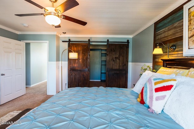 3455 Pine Mist Ct, Rosamond, CA 93560 - carpeted bedroom with a wainscoted wall, a barn door, crown molding, and a ceiling fan