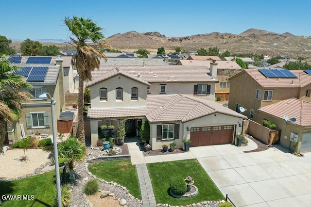 3455 Pine Mist Ct, Rosamond, CA 93560 - mediterranean / spanish home featuring a garage, driveway, stucco siding, a tiled roof, and a residential view