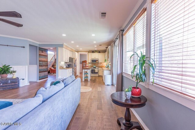 3455 Pine Mist Ct, Rosamond, CA 93560 - living area featuring wainscoting, recessed lighting, stairs, light wood finished floors, and ceiling fan