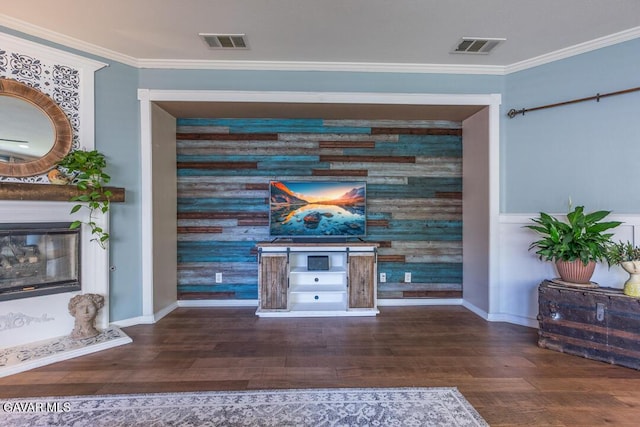 3455 Pine Mist Ct, Rosamond, CA 93560 - detailed view of wood finished floors, wood walls, crown molding, a glass covered fireplace, and an accent wall