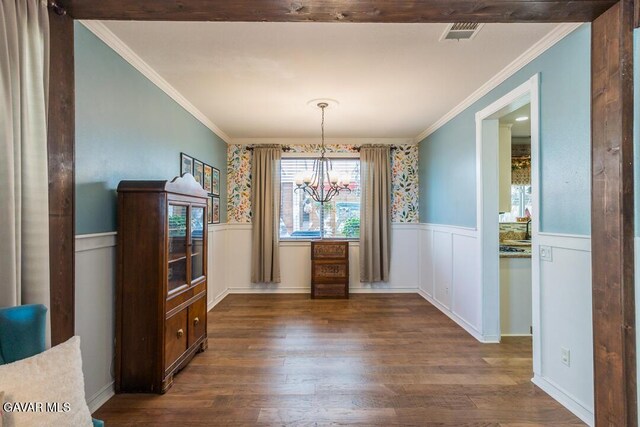 3455 Pine Mist Ct, Rosamond, CA 93560 - unfurnished dining area with a chandelier, a wainscoted wall, wood finished floors, and ornamental molding