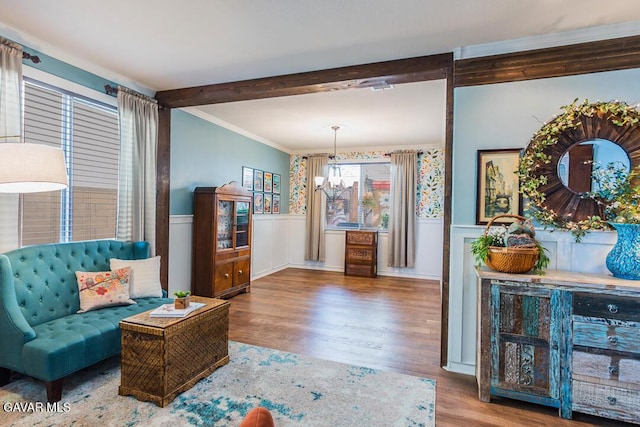 3455 Pine Mist Ct, Rosamond, CA 93560 - living room featuring wainscoting, a chandelier, wood finished floors, beamed ceiling, and ornamental molding