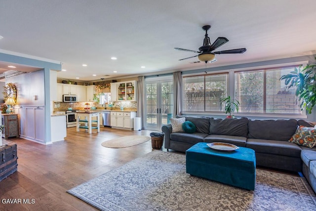 3455 Pine Mist Ct, Rosamond, CA 93560 - living room featuring ceiling fan, wood finished floors, french doors, recessed lighting, and ornamental molding
