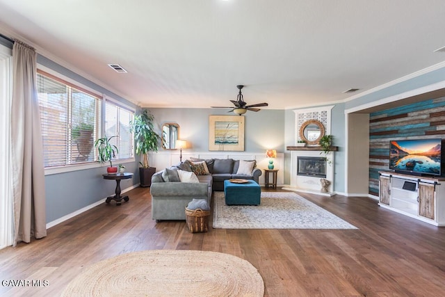 3455 Pine Mist Ct, Rosamond, CA 93560 - living room with a ceiling fan, crown molding, wood finished floors, and a glass covered fireplace