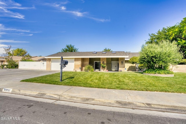 43737 W 27th St, Lancaster, CA 93536 - ranch-style house with brick siding, driveway, a garage, and a front lawn