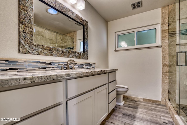 43737 W 27th St, Lancaster, CA 93536 - full bathroom with wood finished floors, a stall shower, vanity, and decorative backsplash