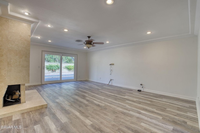 43737 W 27th St, Lancaster, CA 93536 - unfurnished living room featuring crown molding, a ceiling fan, light wood-style flooring, recessed lighting, and a tile fireplace